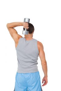 Rear view of a man exercising with dumbbell