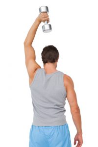 Rear view of a man exercising with dumbbell